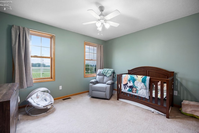 4936 Gibbs Rd, Norwalk, OH 44857 - carpeted bedroom with baseboards, ceiling fan, and a crib