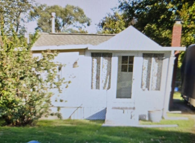 2204 Mills St, Sandusky, OH 44870 - view of side of property featuring a yard and a chimney