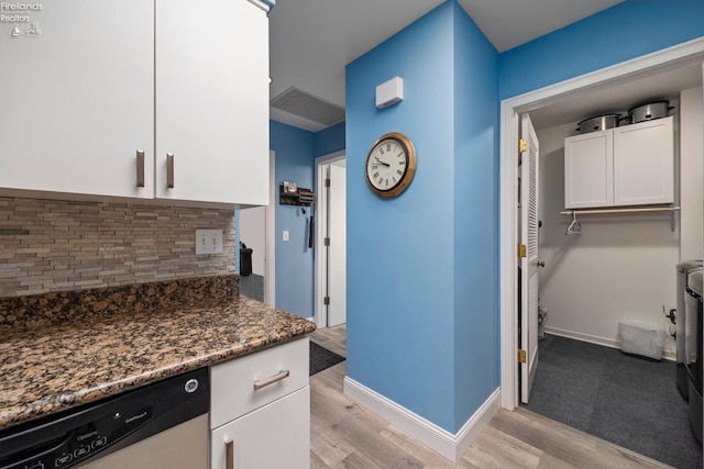 4370 Marin Woods Dr Unit D, Port Clinton, OH 43452 - kitchen featuring dishwasher, light wood-style floors, backsplash, white cabinets, and dark stone countertops
