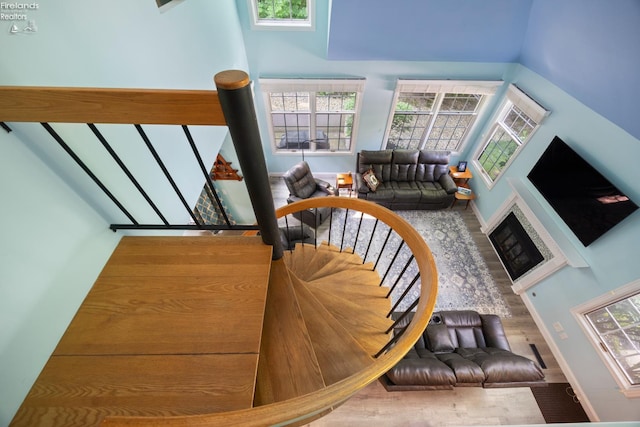 4370 Marin Woods Dr Unit D, Port Clinton, OH 43452 - stairway with wood finished floors, healthy amount of natural light, a towering ceiling, and baseboards