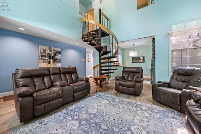 4370 Marin Woods Dr Unit D, Port Clinton, OH 43452 - living room with stairway, a high ceiling, wood finished floors, baseboards, and plenty of natural light