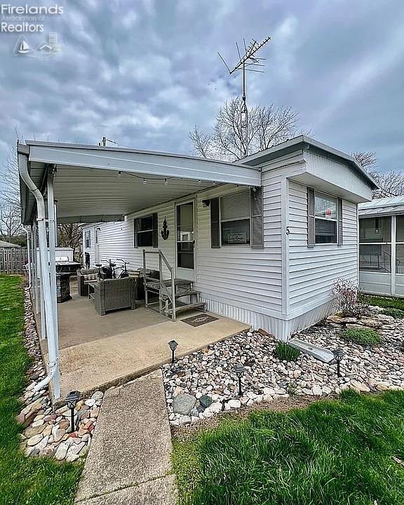 3575 NE Catawba Rd Unit 5, Port Clinton, OH 43452 - rear view of property with entry steps and outdoor lounge area