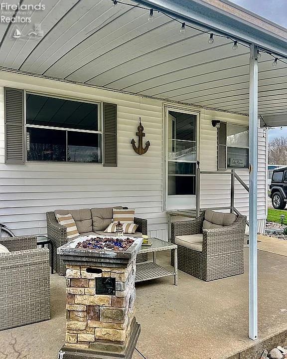 3575 NE Catawba Rd Unit 5, Port Clinton, OH 43452 - view of patio featuring an outdoor fire pit