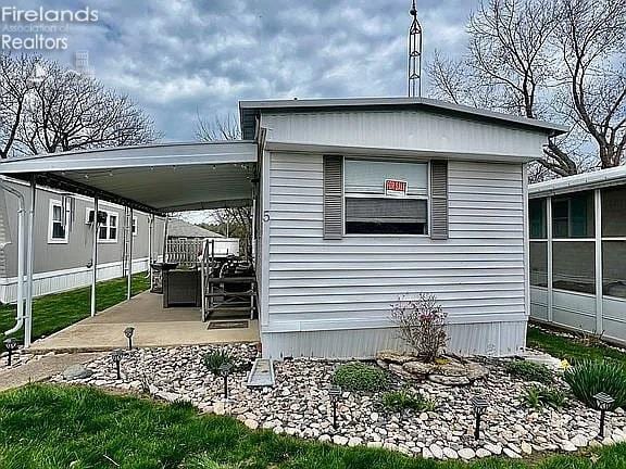 3575 NE Catawba Rd Unit 5, Port Clinton, OH 43452 - view of side of home with a patio area and a sunroom