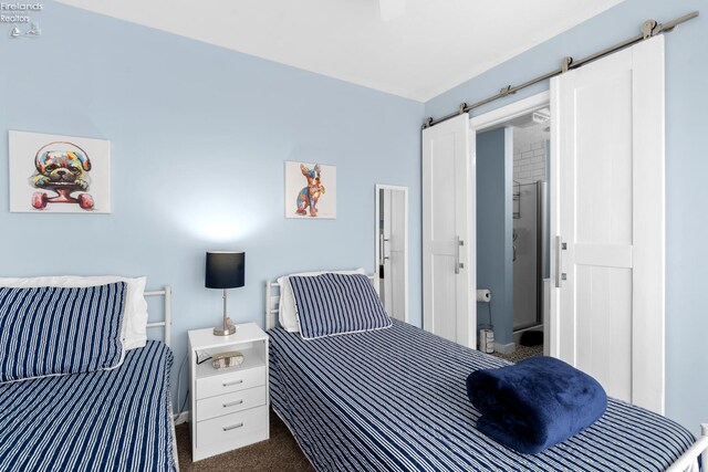 1807 E Perry St Unit 69, Port Clinton, OH 43452 - bedroom featuring a barn door and dark colored carpet