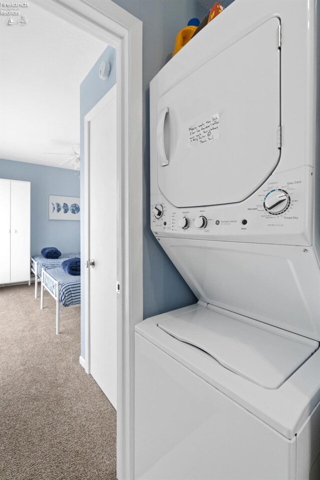 1807 E Perry St Unit 69, Port Clinton, OH 43452 - laundry room featuring stacked washer / dryer, carpet floors, and a ceiling fan