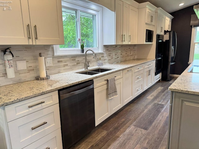 505 E Stoneplace Dr, Sandusky, OH 44870 - kitchen with black appliances, a sink, dark wood finished floors, white cabinetry, and tasteful backsplash