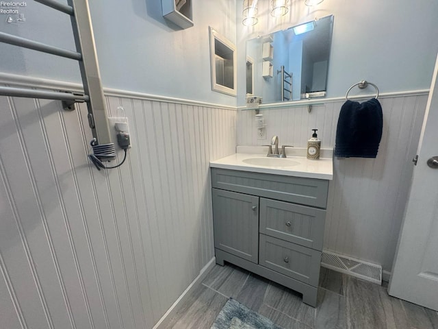 505 E Stoneplace Dr, Sandusky, OH 44870 - bathroom with wainscoting, vanity, and wood finished floors