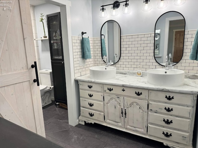 505 E Stoneplace Dr, Sandusky, OH 44870 - bathroom with decorative backsplash, double vanity, toilet, and tile patterned floors