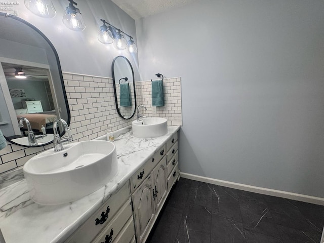 505 E Stoneplace Dr, Sandusky, OH 44870 - full bathroom featuring double vanity, ceiling fan, tasteful backsplash, marble finish floors, and a textured ceiling