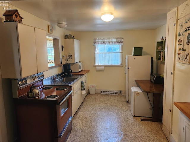 635 Walnut Ave, Lakeside, OH 43440 - kitchen featuring white appliances, a sink, plenty of natural light, and white cabinets