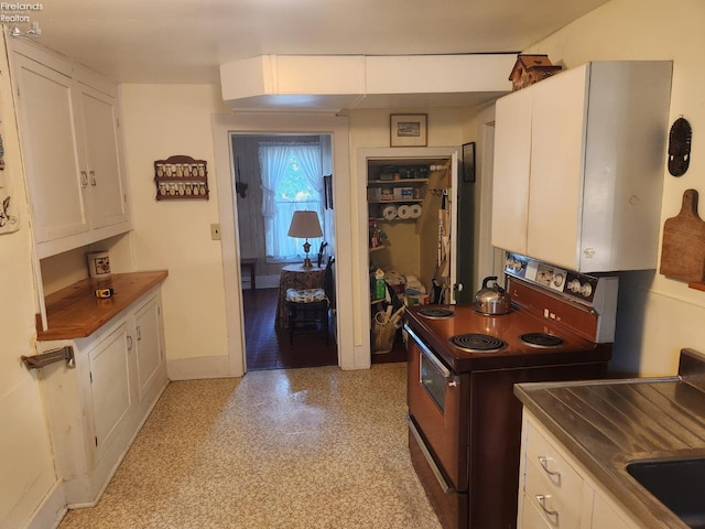 635 Walnut Ave, Lakeside, OH 43440 - kitchen featuring range with electric cooktop, white cabinetry, and baseboards