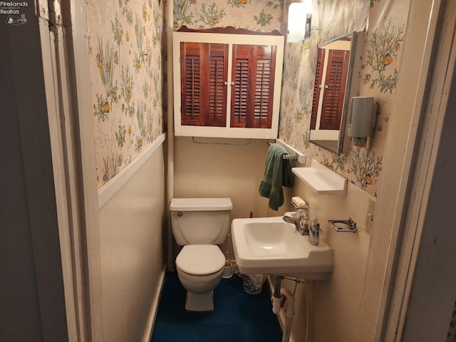 635 Walnut Ave, Lakeside, OH 43440 - half bathroom with wallpapered walls, toilet, and a sink