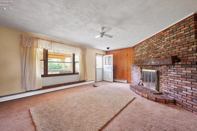 1450 Claus Rd, Vermilion, OH 44089 - unfurnished living room featuring carpet floors, a baseboard radiator, a textured ceiling, a ceiling fan, and a fireplace