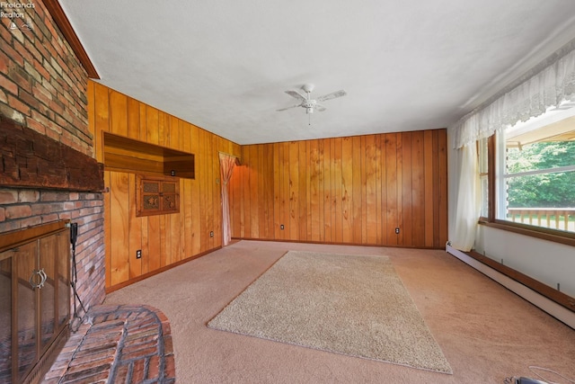 1450 Claus Rd, Vermilion, OH 44089 - unfurnished living room with light colored carpet, wooden walls, a baseboard heating unit, ceiling fan, and a brick fireplace