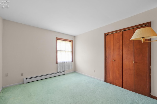 1450 Claus Rd, Vermilion, OH 44089 - unfurnished bedroom with a baseboard radiator, carpet floors, and a closet