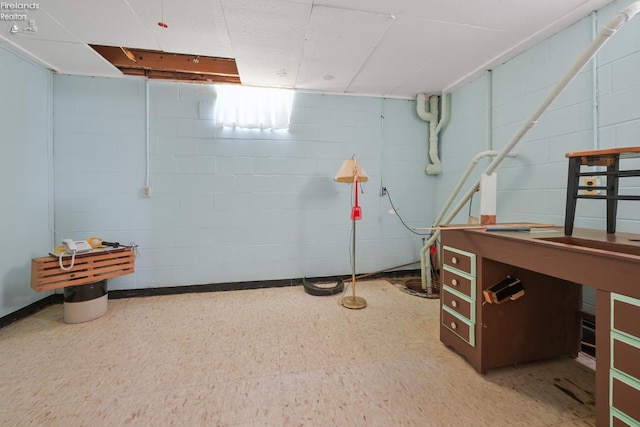 1450 Claus Rd, Vermilion, OH 44089 - finished basement with concrete block wall and tile patterned floors