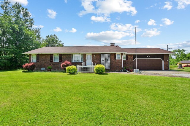 1450 Claus Rd, Vermilion, OH 44089 - single story home featuring brick siding, driveway, a garage, and a front yard