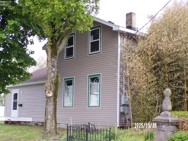 118 E Buckeye St, Clyde, OH 43410 - rear view of property featuring a chimney