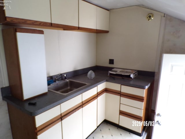 118 E Buckeye St, Clyde, OH 43410 - kitchen featuring a sink, dark countertops, and white cabinetry