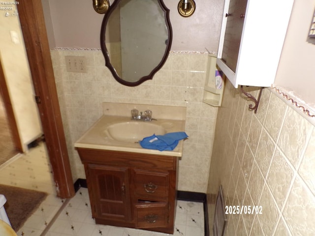 118 E Buckeye St, Clyde, OH 43410 - half bath featuring tile walls, vanity, a wainscoted wall, and tile patterned floors
