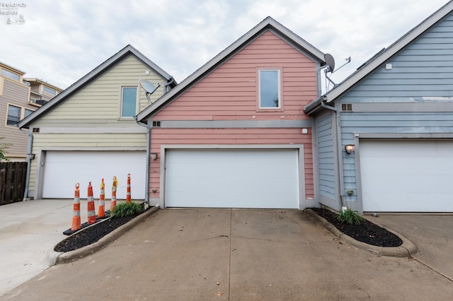 1402 Newman Ave, Lakewood, OH 44107 - view of front facade featuring concrete driveway and a garage