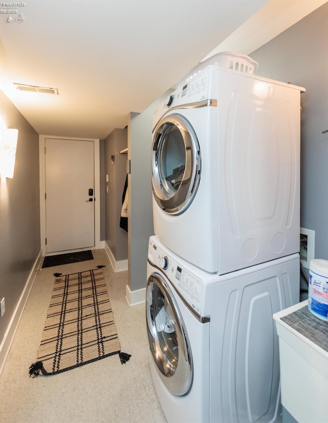 1402 Newman Ave, Lakewood, OH 44107 - laundry area featuring stacked washer and clothes dryer and baseboards
