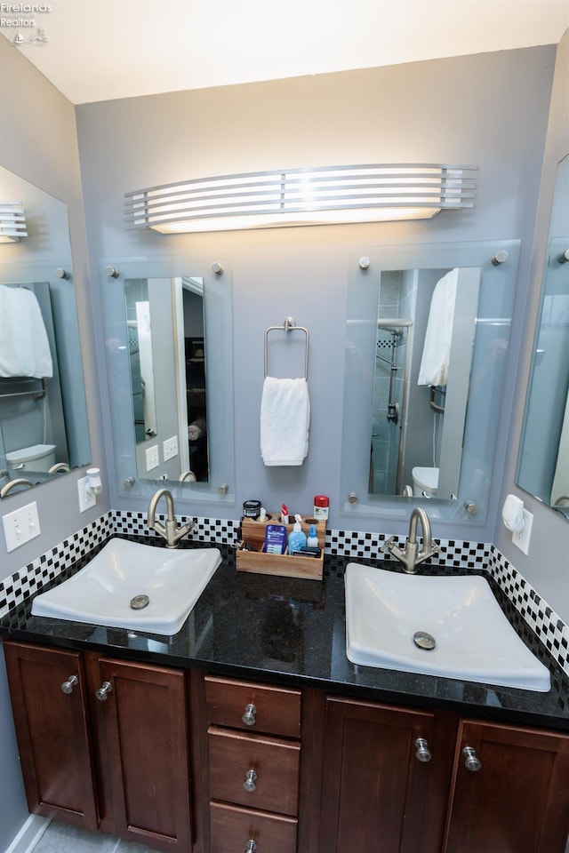 1402 Newman Ave, Lakewood, OH 44107 - full bathroom with double vanity, backsplash, and a shower with shower door