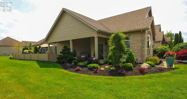 3826 Windsor Bridge Cir, Huron, OH 44839 - view of side of property featuring a lawn, a shingled roof, and stone siding