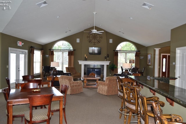 3826 Windsor Bridge Cir, Huron, OH 44839 - carpeted dining area featuring a premium fireplace, ceiling fan, and high vaulted ceiling