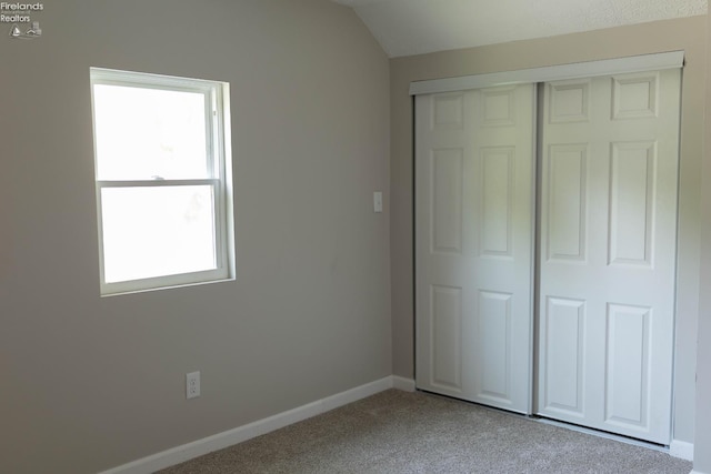 15 Abbott St, Wakeman, OH 44889 - unfurnished bedroom featuring carpet flooring, a closet, and lofted ceiling
