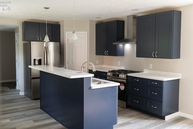 15 Abbott St, Wakeman, OH 44889 - kitchen with wall chimney range hood, appliances with stainless steel finishes, light wood finished floors, light countertops, and an island with sink