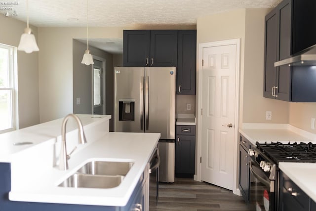 15 Abbott St, Wakeman, OH 44889 - kitchen with appliances with stainless steel finishes, dark wood-style floors, wall chimney range hood, light countertops, and decorative light fixtures