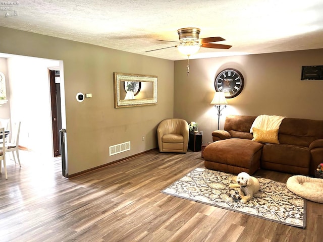 9 Eagle Way, Norwalk, OH 44857 - living area with wood finished floors, a ceiling fan, and a textured ceiling