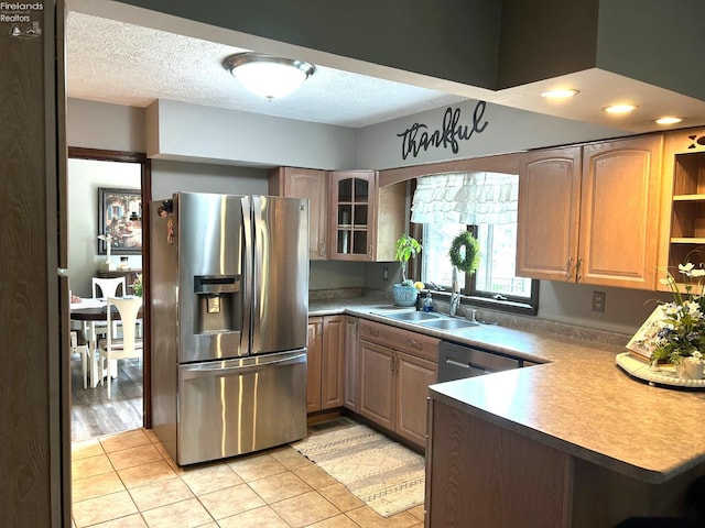9 Eagle Way, Norwalk, OH 44857 - kitchen with stainless steel refrigerator with ice dispenser, glass insert cabinets, light tile patterned flooring, a peninsula, and a textured ceiling