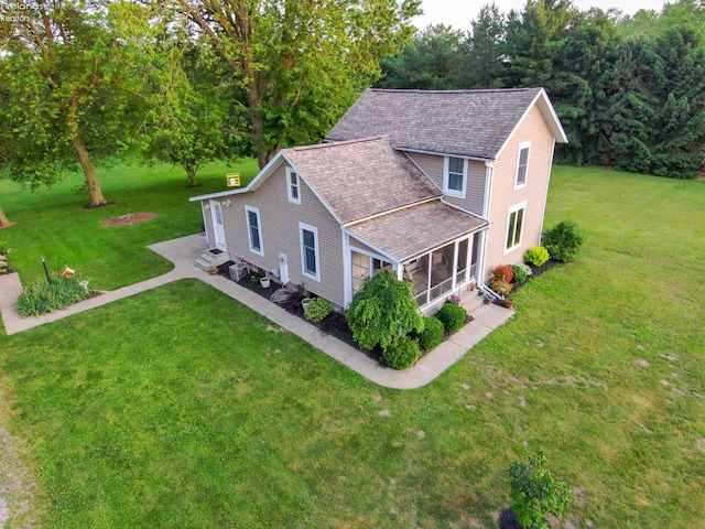 4647 Crk 175, Clyde, OH 43410 - view of front facade with a shingled roof, a front yard, and a sunroom