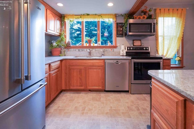 4647 Crk 175, Clyde, OH 43410 - kitchen featuring stainless steel appliances, recessed lighting, light stone countertops, and brown cabinets