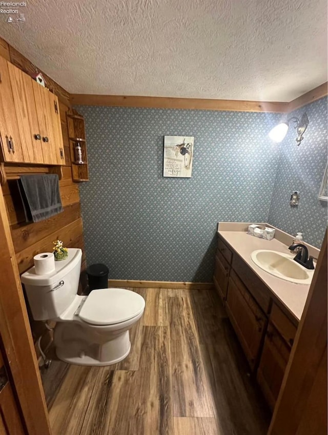 37 State Route 60, New London, OH 44851 - half bathroom with wood finished floors, a textured ceiling, and vanity