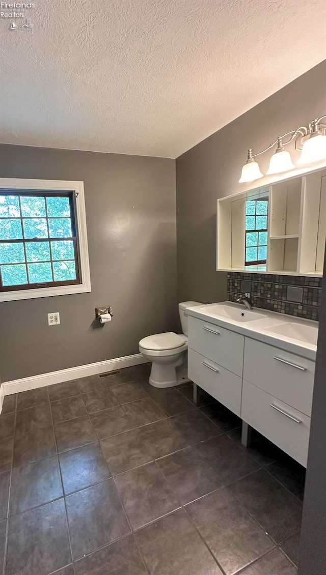 37 State Route 60, New London, OH 44851 - bathroom featuring vanity, a textured ceiling, decorative backsplash, and tile patterned flooring