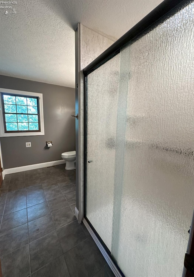 37 State Route 60, New London, OH 44851 - bathroom featuring a shower stall, a textured ceiling, and tile patterned flooring