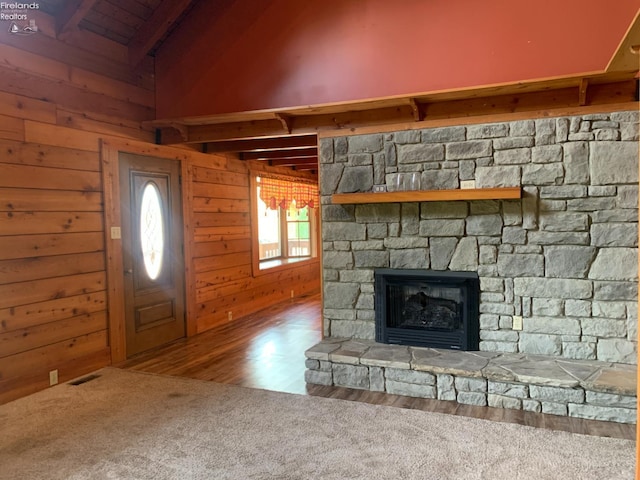 37 State Route 60, New London, OH 44851 - unfurnished living room with a fireplace, wood walls, and wood finished floors