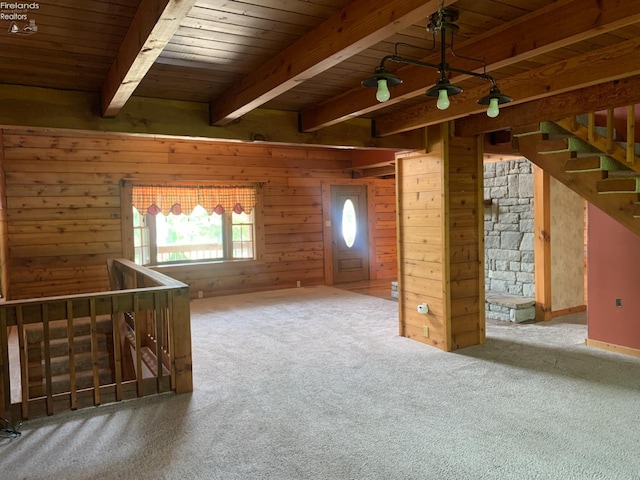 37 State Route 60, New London, OH 44851 - carpeted empty room with wood walls and a wood ceiling with exposed beams