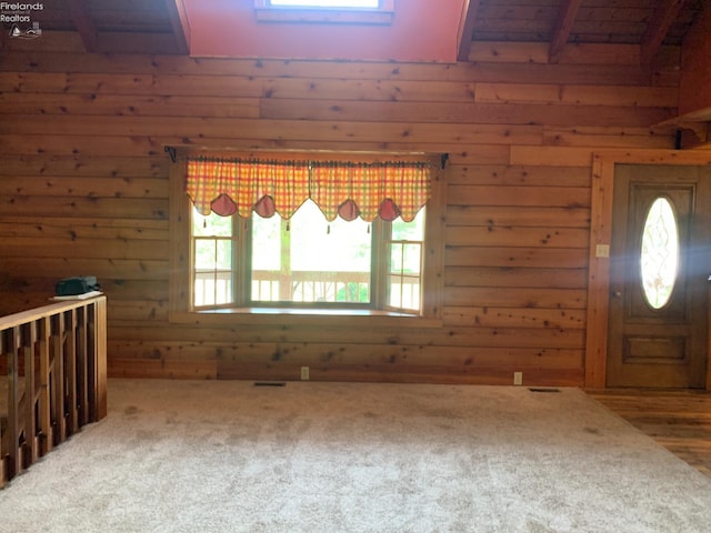 37 State Route 60, New London, OH 44851 - entryway with wooden walls, plenty of natural light, beam ceiling, and carpet floors