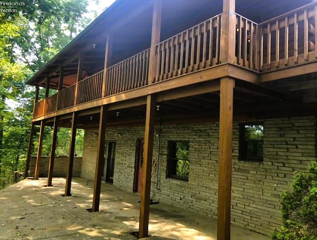 37 State Route 60, New London, OH 44851 - view of home's exterior featuring a deck, brick siding, and a patio area