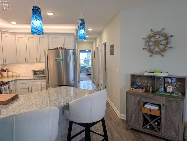 2620 S Waterside Ct Unit 622, Marblehead, OH 43440 - kitchen with freestanding refrigerator, dark wood finished floors, white cabinetry, light stone countertops, and recessed lighting