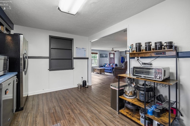 46320 Middle Ridge Rd, Amherst, OH 44001 - kitchen with dark wood-style flooring, stainless steel appliances, a textured ceiling, ceiling fan, and open floor plan