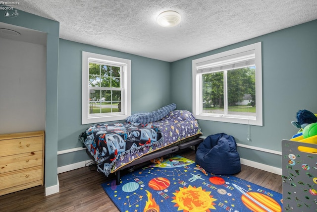 46320 Middle Ridge Rd, Amherst, OH 44001 - bedroom featuring wood finished floors and a textured ceiling