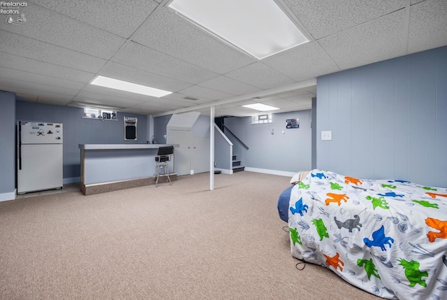 46320 Middle Ridge Rd, Amherst, OH 44001 - basement with freestanding refrigerator, a bar, carpet floors, a paneled ceiling, and stairway