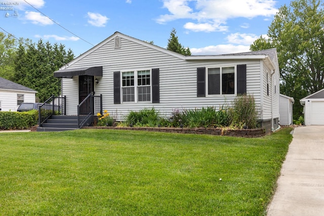 46320 Middle Ridge Rd, Amherst, OH 44001 - view of front of house featuring a front lawn, an outdoor structure, a detached garage, and concrete driveway