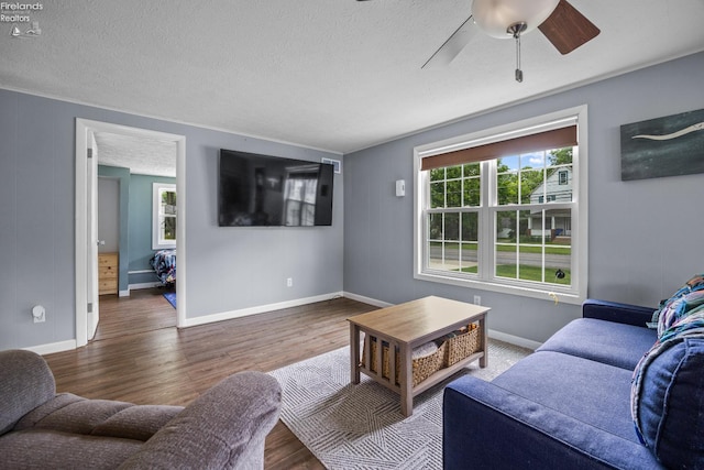 46320 Middle Ridge Rd, Amherst, OH 44001 - living area with wood finished floors, a textured ceiling, and ceiling fan